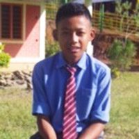A young man in a blue shirt and red tie.
