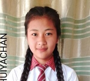 A young girl with long braids wearing a tie.