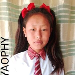 A young girl with long hair and red bow ties.