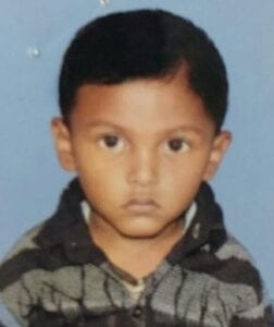 A young boy with brown eyes and black hair.
