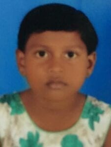 A young boy with green eyes and white shirt.