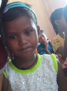 A young girl is smiling for the camera.