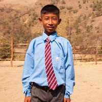 A young man in a blue shirt and tie.