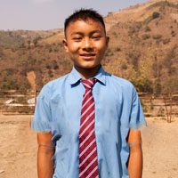 A young man wearing a blue shirt and red tie.