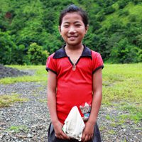 A girl holding a rock in her hands.
