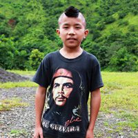 A young boy with an afro and a t-shirt.