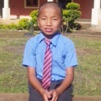 A young boy in a blue shirt and tie.