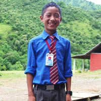 A young boy in blue shirt and red tie.