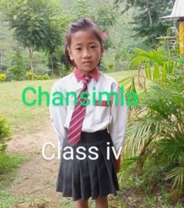 A young girl in school uniform standing on the side of a road.