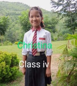 A girl in school uniform standing outside.