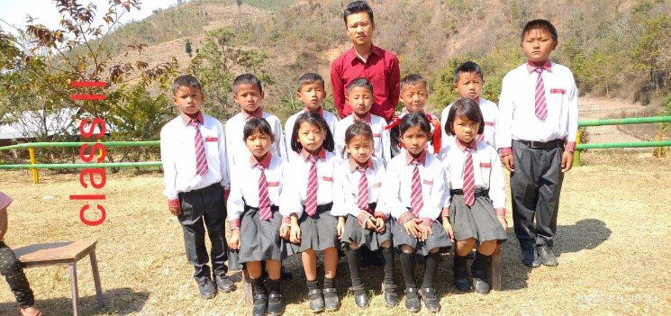 A group of children in school uniforms posing for a picture.