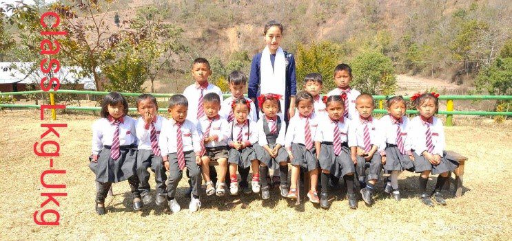 A group of children in school uniforms posing for a picture.