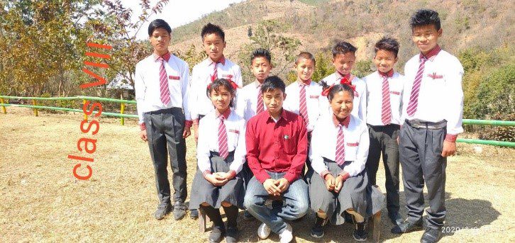 A group of young people in school uniforms posing for the camera.
