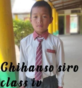 A young boy in a tie and shirt.