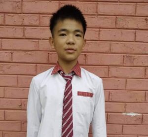 A young man wearing a tie and shirt.