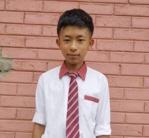 A young man wearing a tie and shirt.