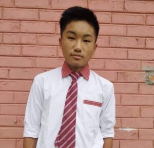 A young man wearing a red tie and white shirt.