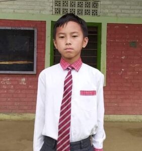 A young boy in a white shirt and red tie.