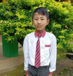 A young boy in a tie and shirt.