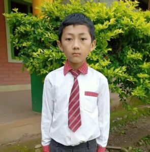 A young boy in a tie and shirt.