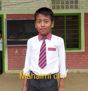 A young boy in a tie and white shirt.