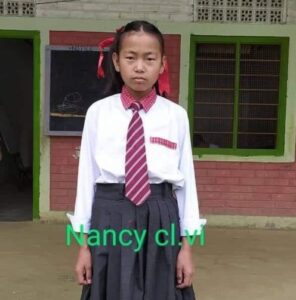 A girl in school uniform standing outside of a building.