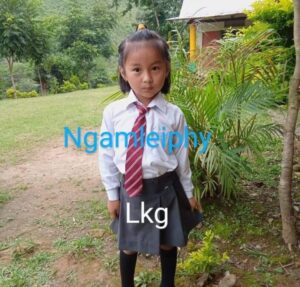 A girl in school uniform standing outside.