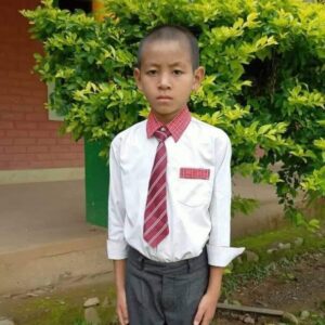 A young boy in a tie and white shirt.