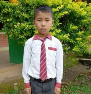 A young boy in a tie and shirt.