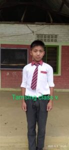 A boy in a tie and white shirt