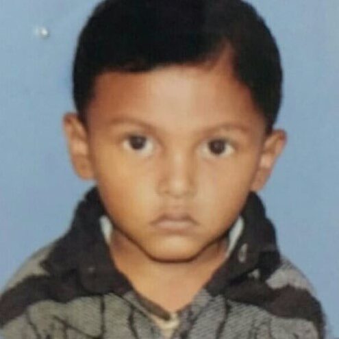 A young boy with brown eyes and black hair.