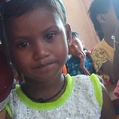 A young girl is smiling for the camera.