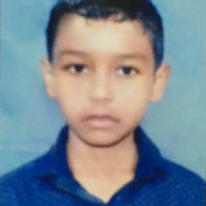 A young boy is wearing a blue shirt.