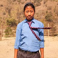 A young man wearing a tie and a blue shirt.