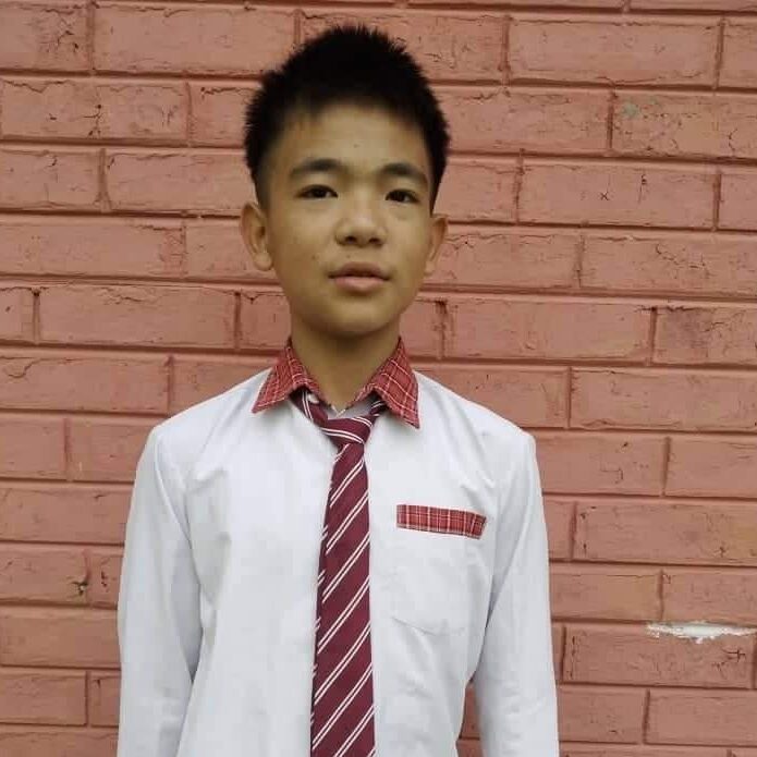 Livingson Shagolshem Class VIII A young man wearing a tie and shirt.