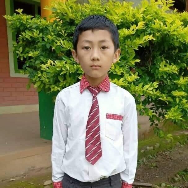 A young boy in a tie and shirt.
