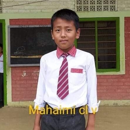 A young boy in a tie and white shirt.