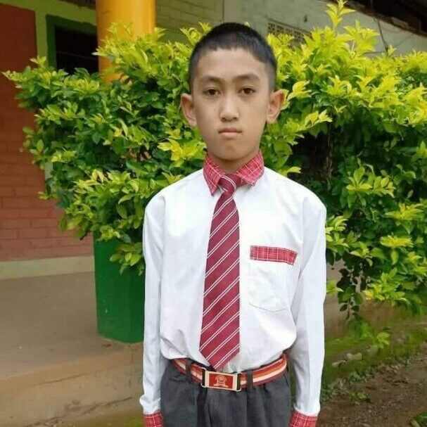 A young boy in a red tie and white shirt.