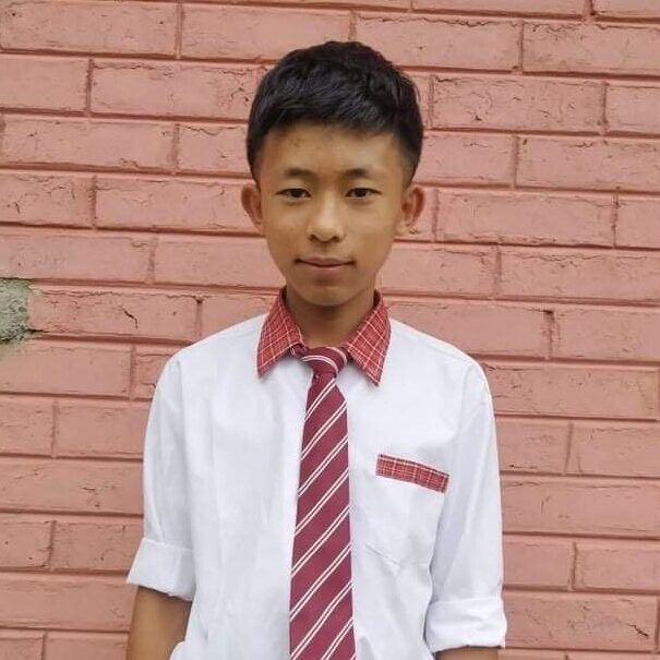 A young man wearing a tie and shirt.