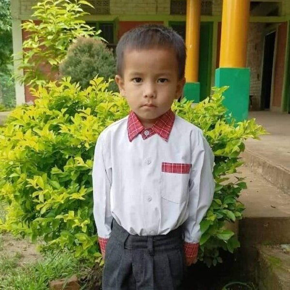 A young boy in a white shirt and red tie.