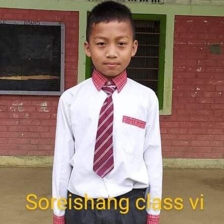 Soreishang Class VI A young boy wearing a tie and white shirt.
