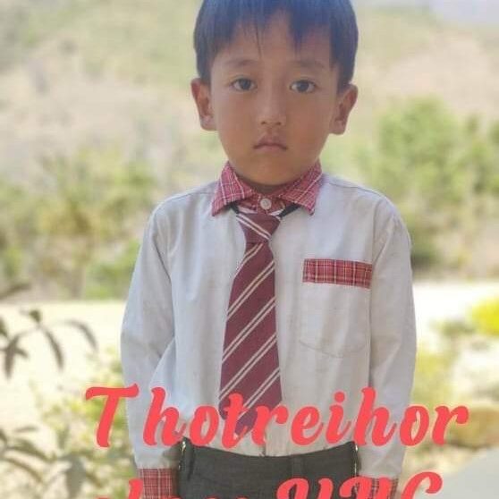 A young boy wearing a tie and shirt.