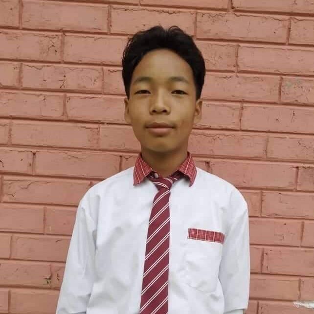 A young man wearing a tie and shirt.